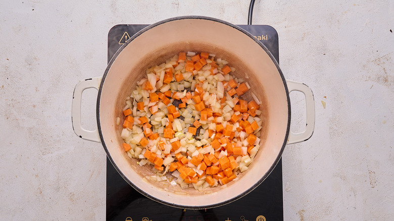 cooking carrot and onion in pot