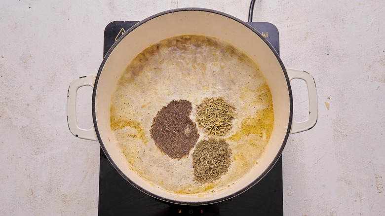 chicken broth and seasonings in pot