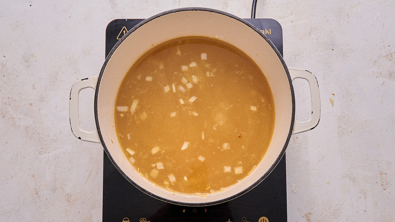 boiling potatoes in pot with broth