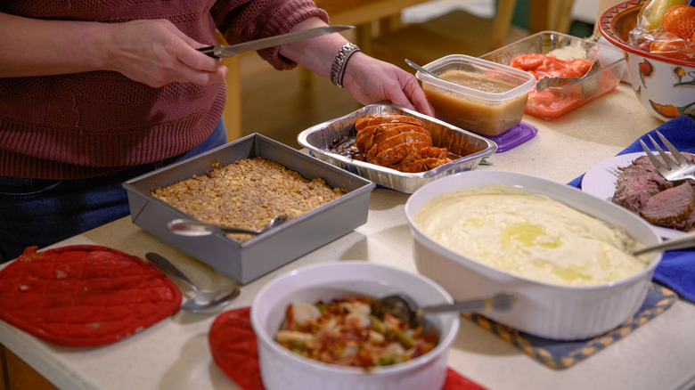 preparing meal for crowd in kitchen