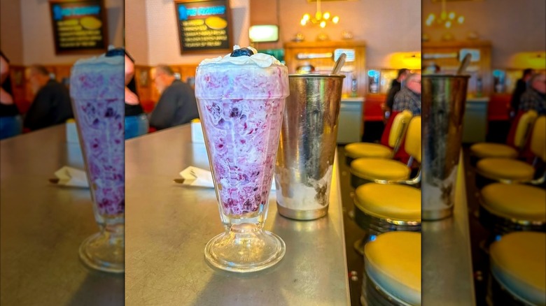 Pieshake in tall glass topped with whipped cream and berry