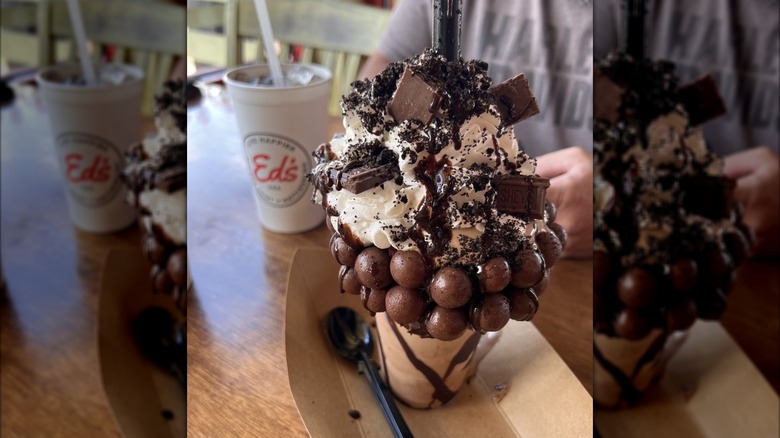 Extravagant shake adorned with chocolate candies and whipped cream