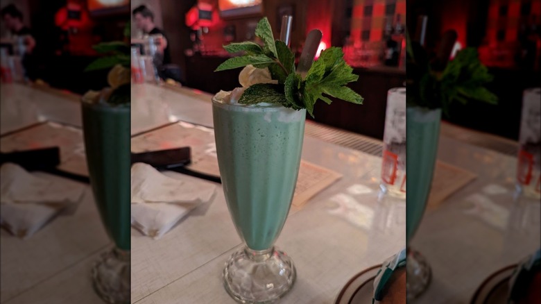 Grasshopper shake garnished with mint in tall glass