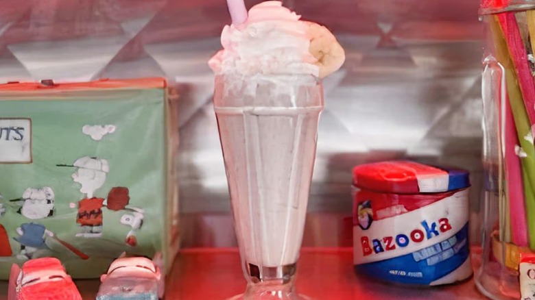 Milkshake topped with whipped cream and sliced banana