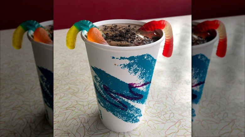 Chocolate milkshake with crumbled Oreos and gummy worms