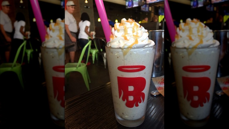 Caramel pretzel milkshake topped with whipped cream and caramel