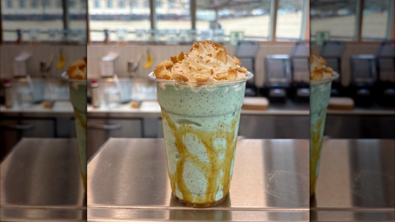Mint chocolate chip and vanilla milkshake drizzled with caramel and topped with whipped cream and vanilla wafer pieces