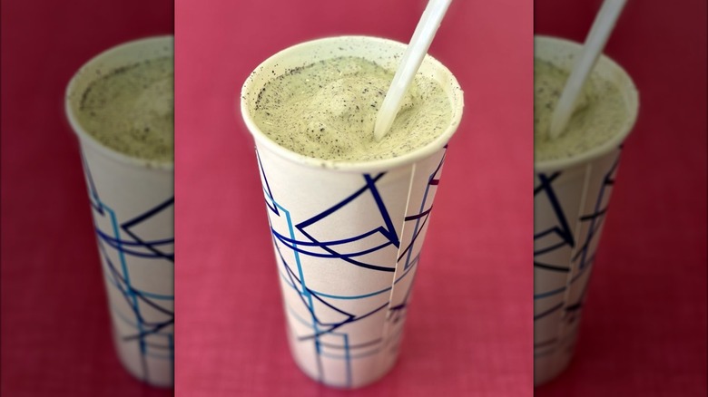 Grasshopper shake in paper to-go cup with straw