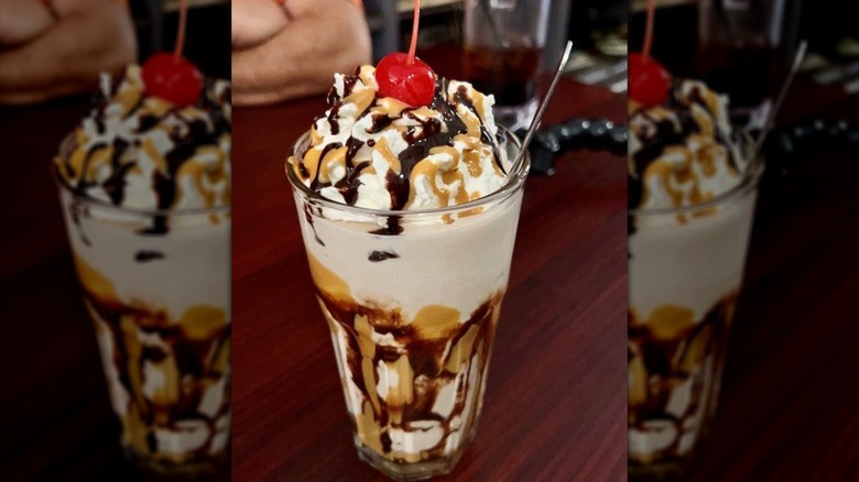 Milkshake drizzled in chocolate and caramel sauce, topped with cherry