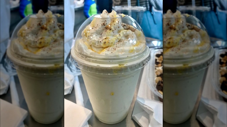 Eggnog shake topped with whipped cream in plastic to-go cup