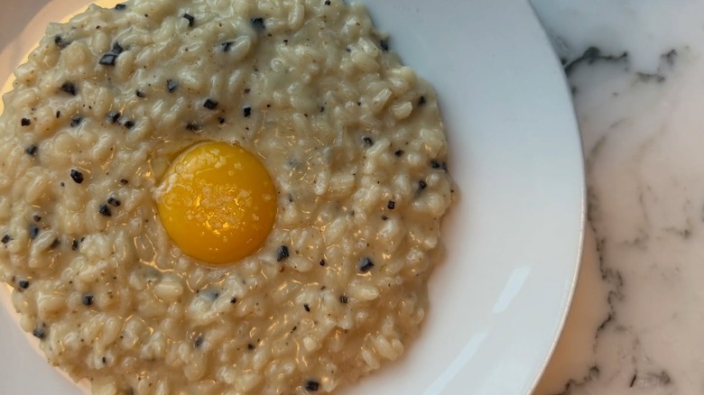 Truffle risotto topped with egg yolk at Cascina Spinasse