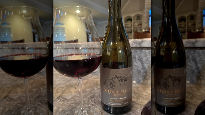 2017 Ghost Hill Cellars Prospector's Reserve Pinot Noir with glass of wine next to it