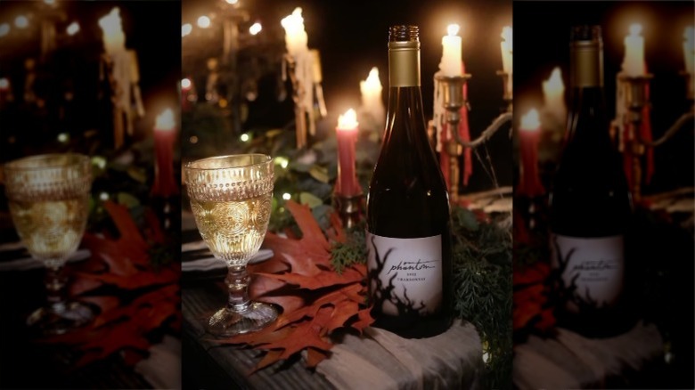 Phantom Chardonnay on a table with glass and candles