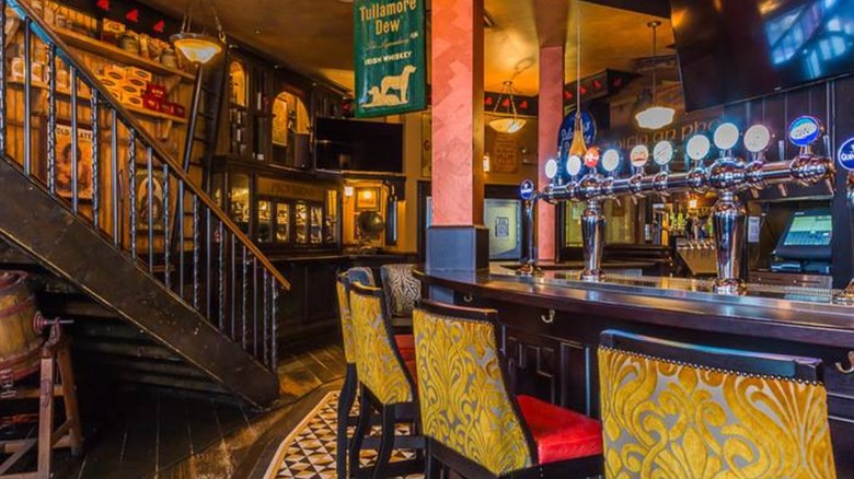 Interior of Fado with bar and chairs, staircase, and Tullamore Dew flag