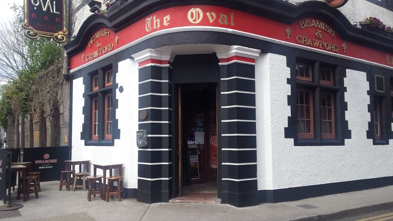 Front door of The Oval pub black and white building