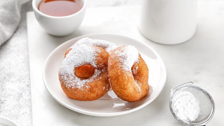 Powdered sugar donuts on plate