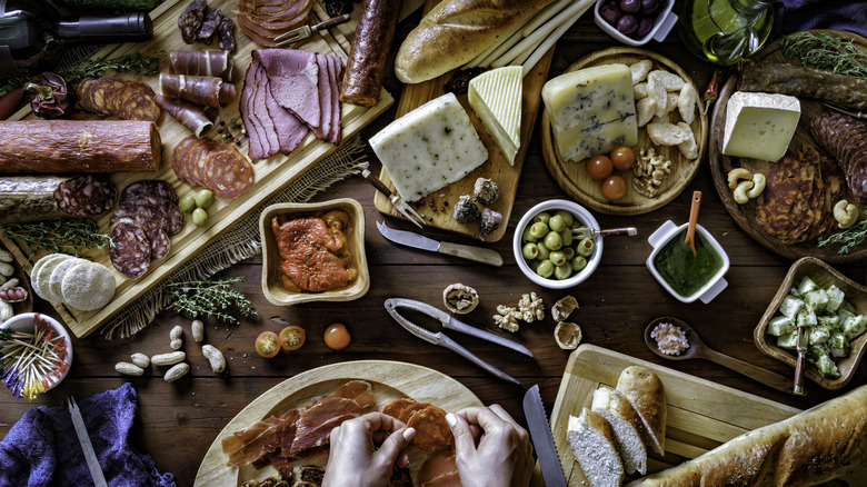 elaborate cheese board with utensils