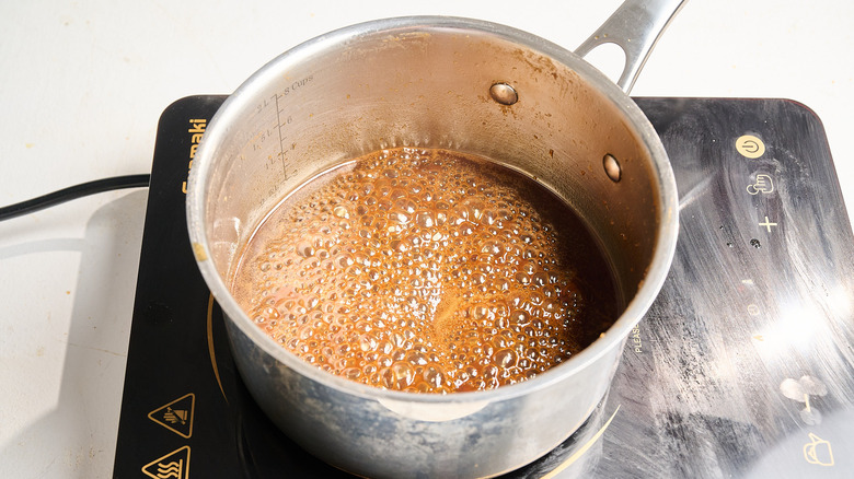 simmering reserved marinade in saucepan