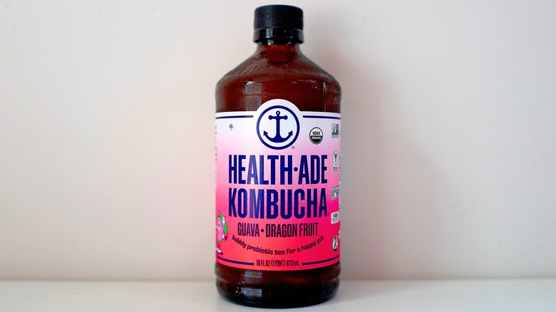 Bottle of Health-Ade Guava Dragon Fruit Kombucha on white table