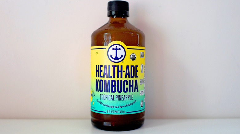 Bottle of Health-Ade Tropical Pineapple Kombucha on white table