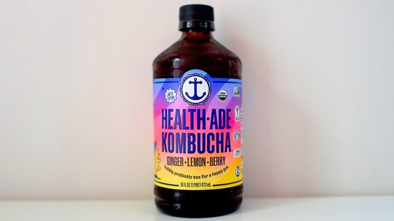 Bottle of Health-Ade Ginger Lemon Berry Kombucha on white table