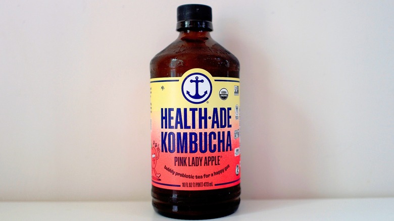 Bottle of Health-Ade Pink Lady Apple Kombucha on white table