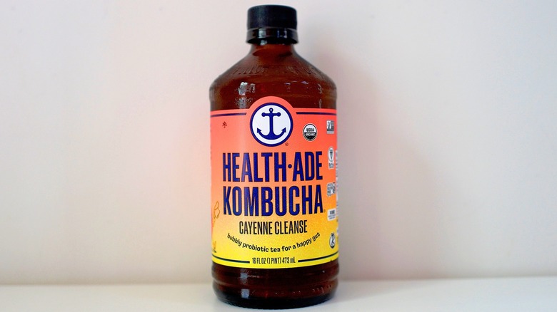 Bottle of Health-Ade Cayenne Cleanse Kombucha on white table