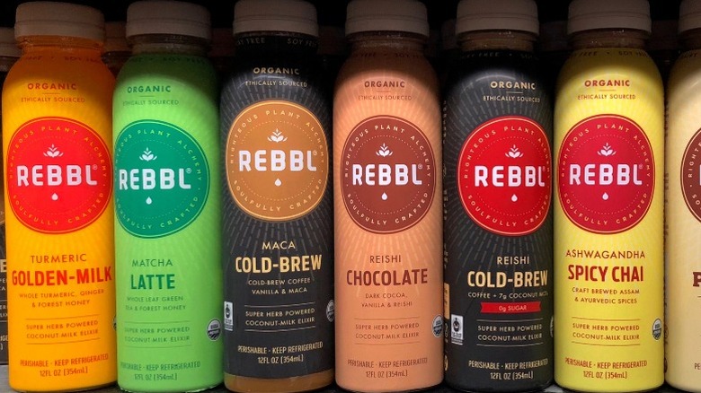 Different flavored bottles of Rebbl energy drinks in a row