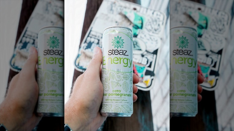 Person holding a can of Steaz yerba mate drink