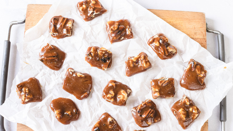 Cut of pieces of shiny Oklahoma candy on a piece of parchment paper