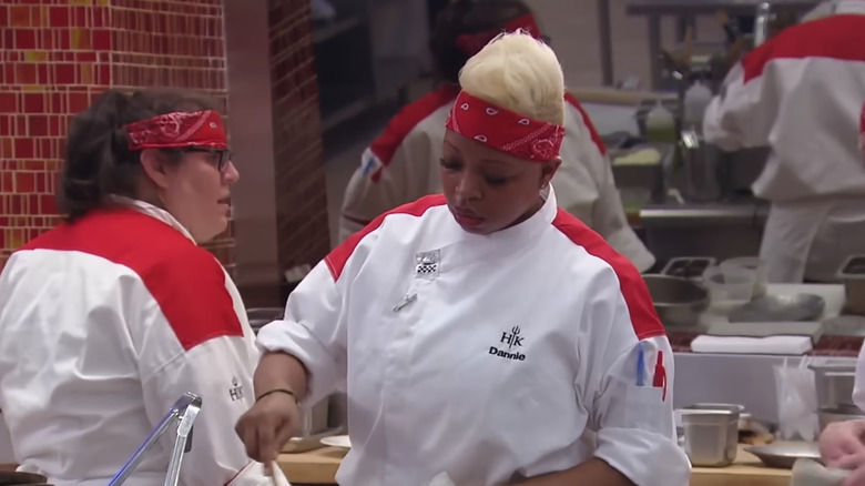 "Hell's Kitchen" contestants wearing red bandanas cooking