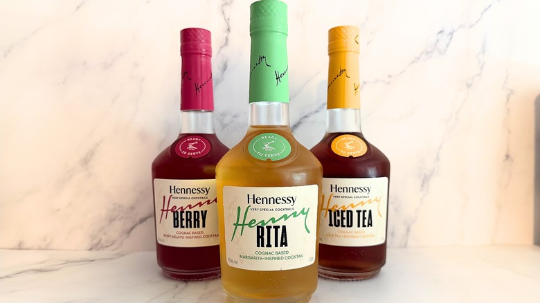 Bottles of Hennessy Very Special Cocktails in triangle formation on marble background