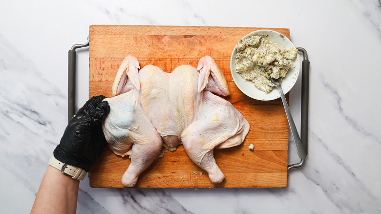 Pulling skin over chicken loose