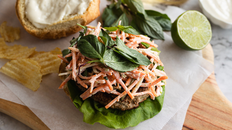 Open turkey burger with carrot slaw and Thai basil, chip and lime