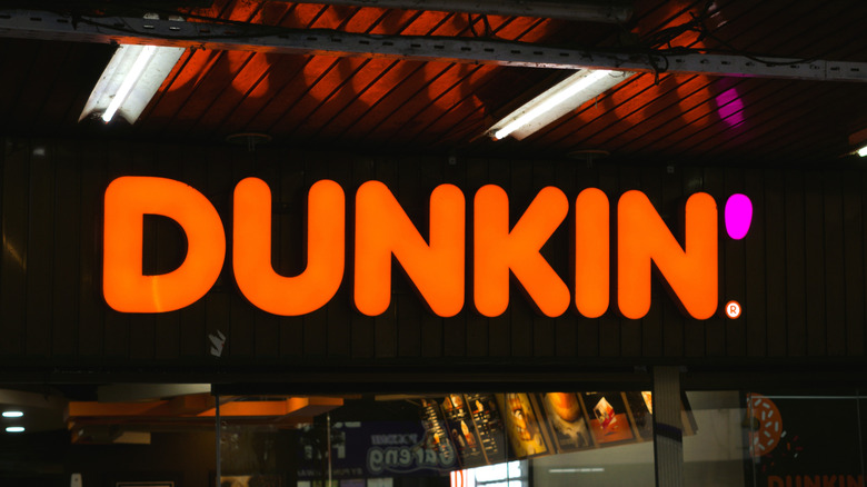 Lit up Dunkin' sign at night