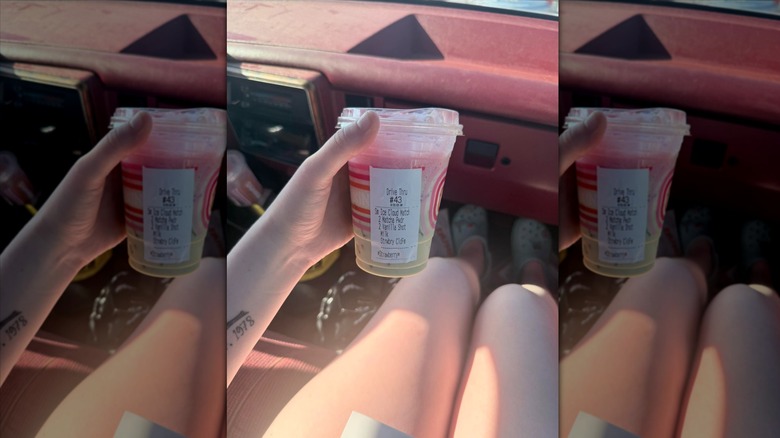 Hand holding cup of Strawberry Cloud Matcha