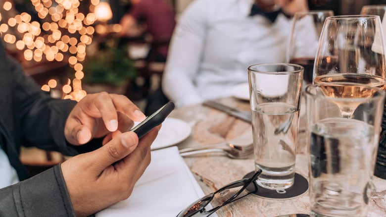 Man Using Mobile Phone at Fine Dining Resturant