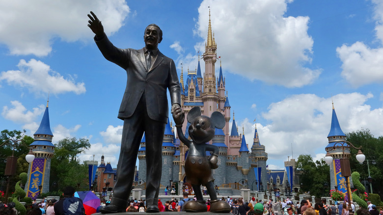 Statue of Walt Disney and Mickey Mouse in front of Cinderella's Castle in the Magic Kingdom at Walt Disney World