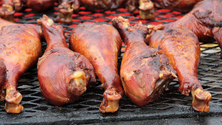 Large smoked turkey legs on a grill