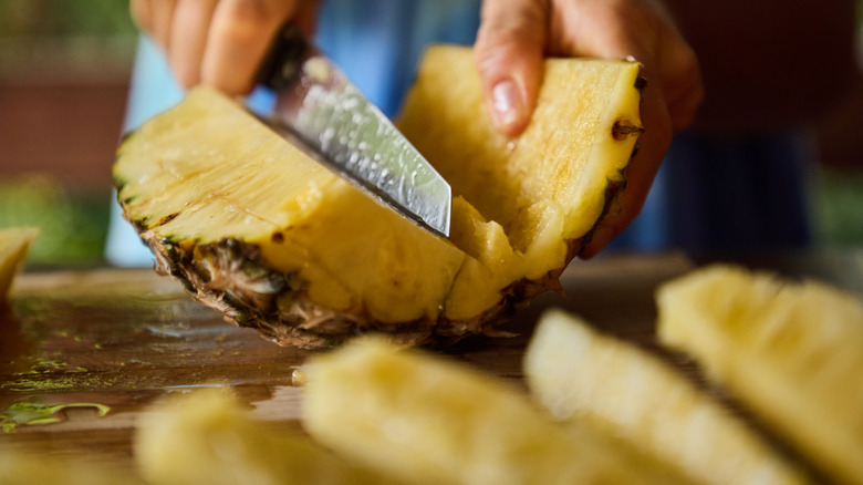 cutting pineapple