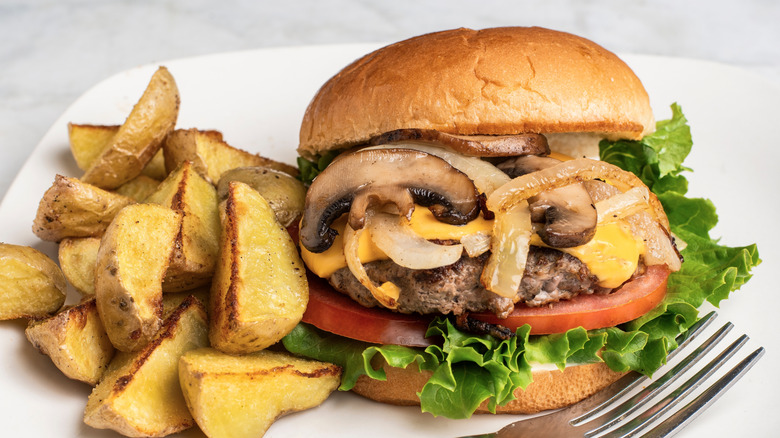 Burger with mushrooms, cheese, and onions