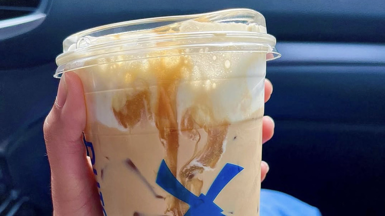 Customer holding Soft Top drink