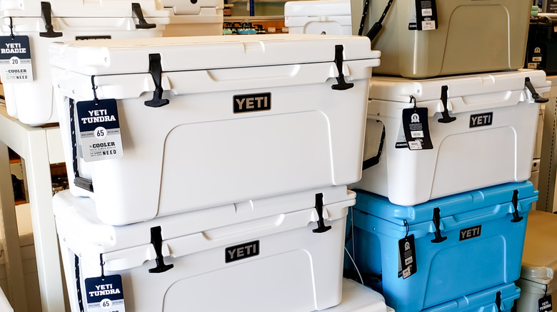 A stack of blue and white Yeti coolers
