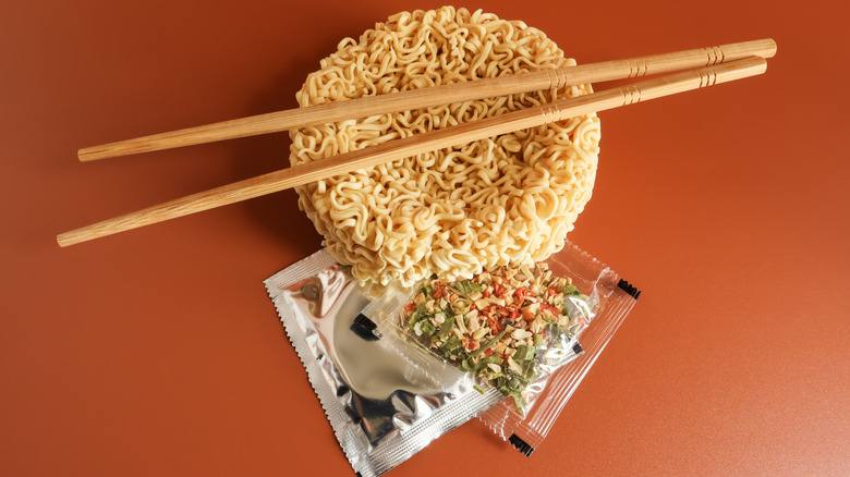 Overhead view of components of instant ramen noodles package on a surface