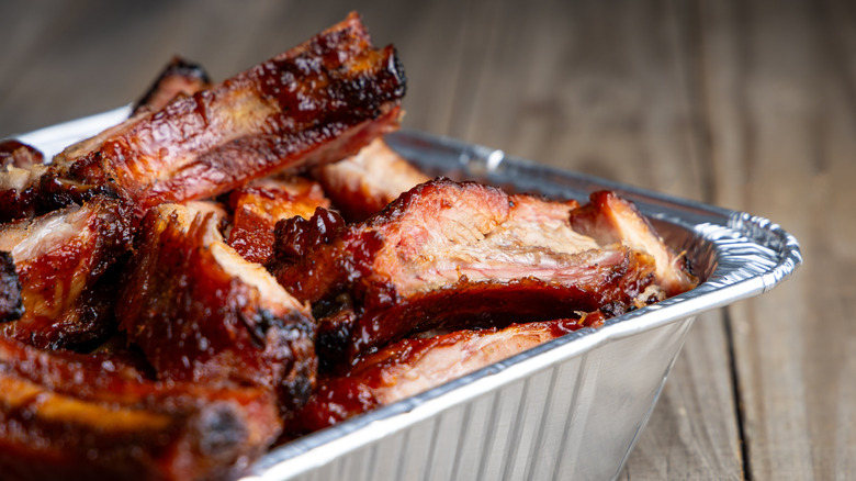 Sliced baby back ribs in aluminum container