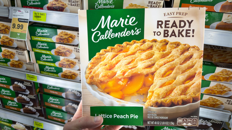 Holding Marie Callender's peach pie in grocery store