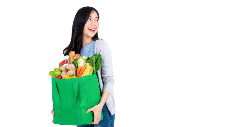 Woman reusable bag with groceries
