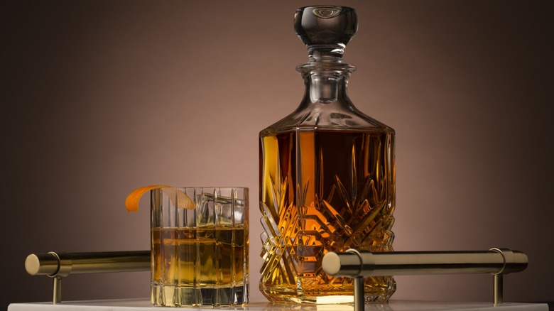 A whiskey decanter and a whiskey cocktail