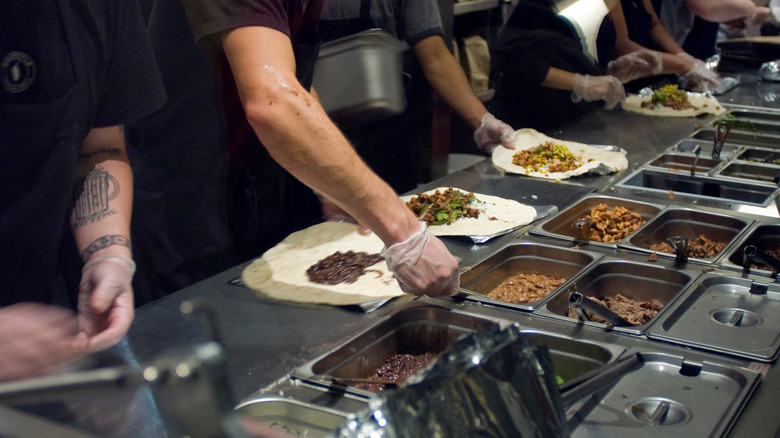 Chipotle workers assembling burritos