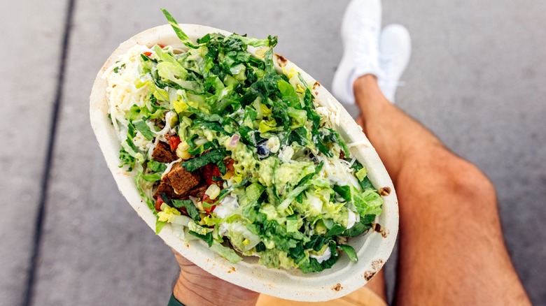 person holding a Chipotle bowl